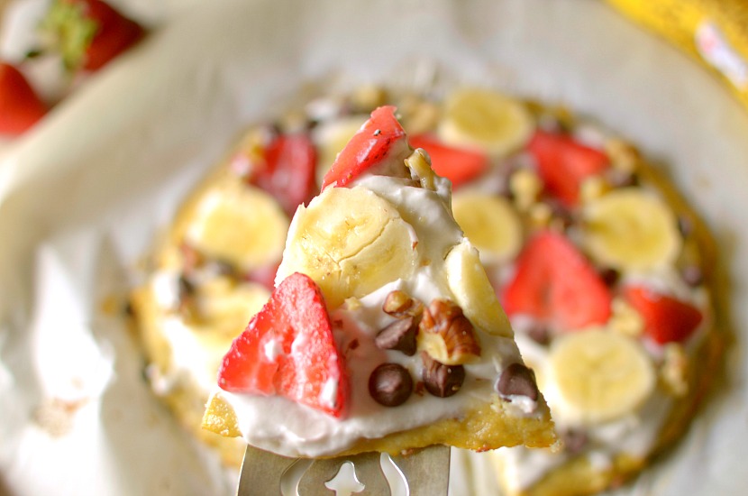 This Healthy Banana Bread Fruit Pizza is a delicious dessert, breakfast or snack! It has a banana bread-like crust and is topped with a strawberry cream cheese frosting, fruit, nuts and chocolate. It is completely gluten-free, paleo and has a vegan option!