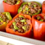 Healthy Burrito Bowl Stuffed Peppers are a delicious dinner that tastes exactly like a chipotle burrito bowl in pepper form! Also paleo, vegan and whole 30!