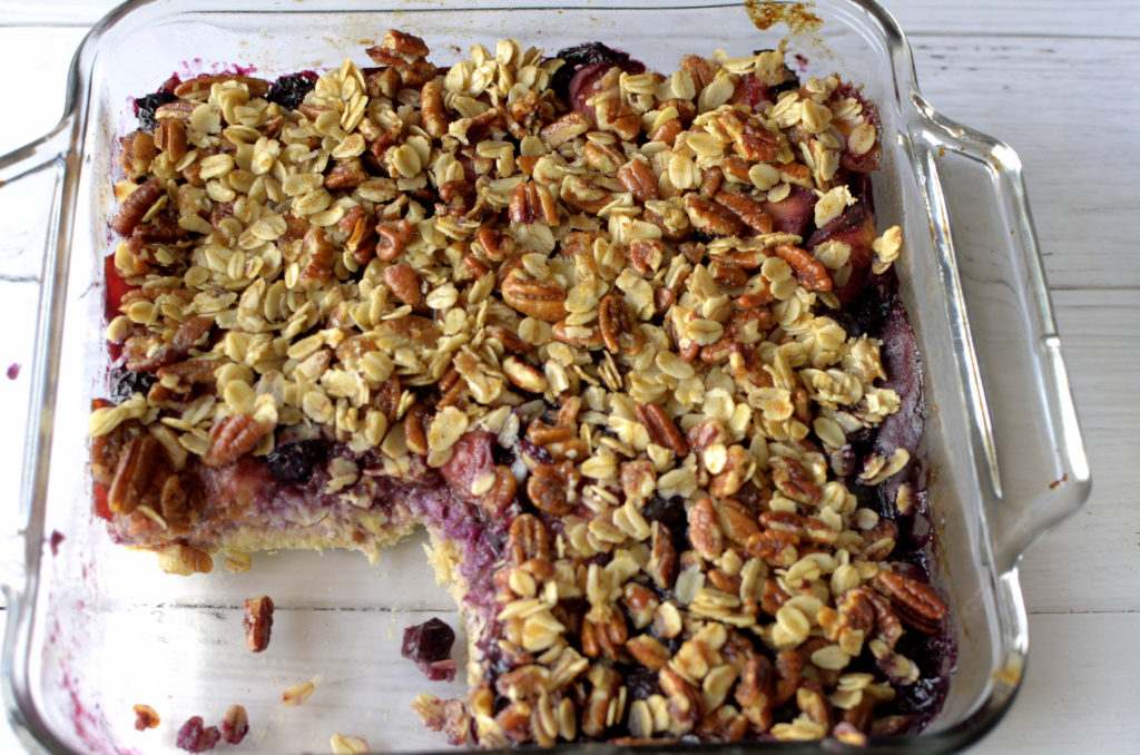 This Blueberry Peach Baked Oatmeal is topped with a scrumptious streusel is the perfect healthy breakfast that tastes like dessert. It is filled with fresh summer fruit and is vegan & gluten-free!